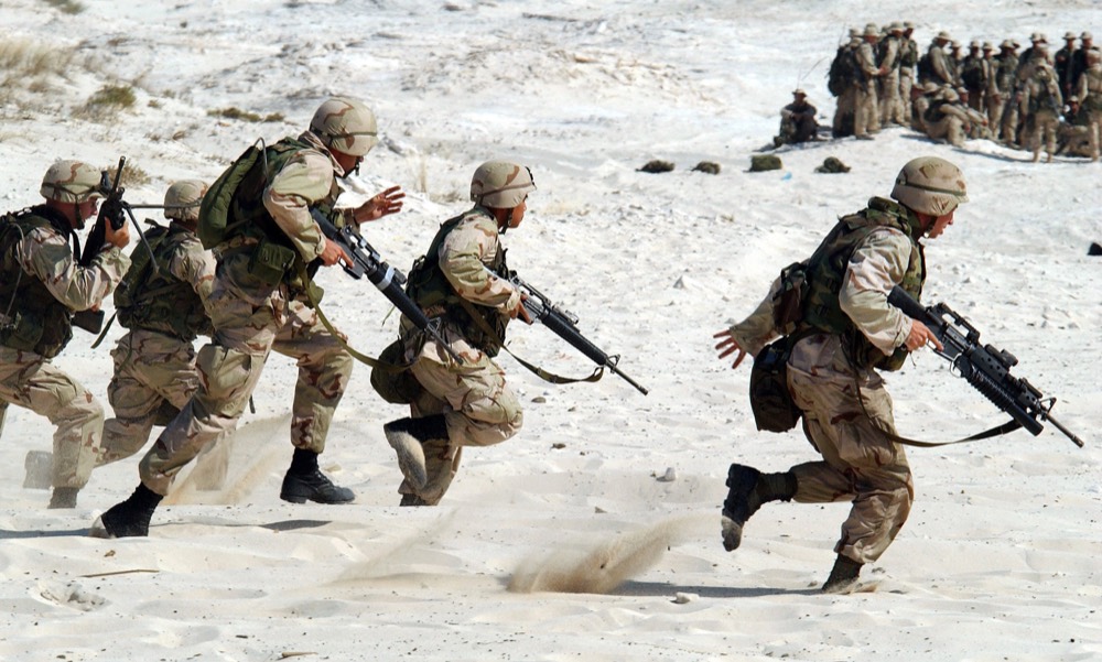 Infantry section advancing across open desert terrain
